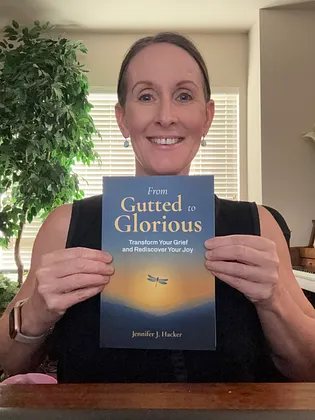 Jennifer Hacker holding From Gutted to Glorious